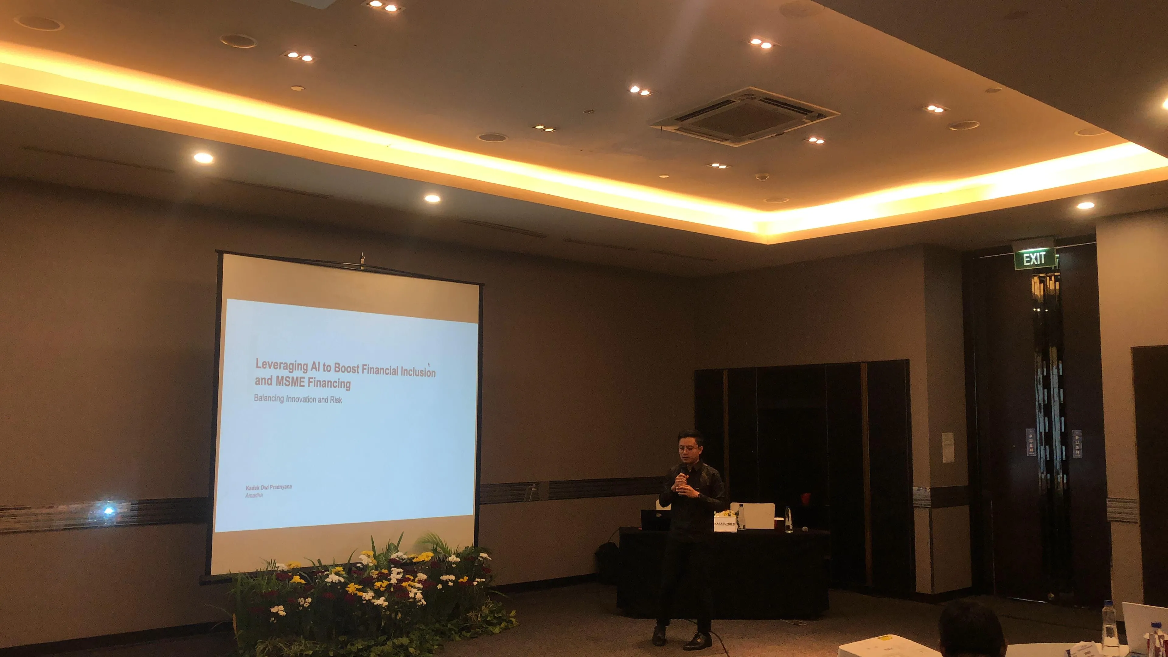 Presenting on AI for Financial Inclusion at a conference